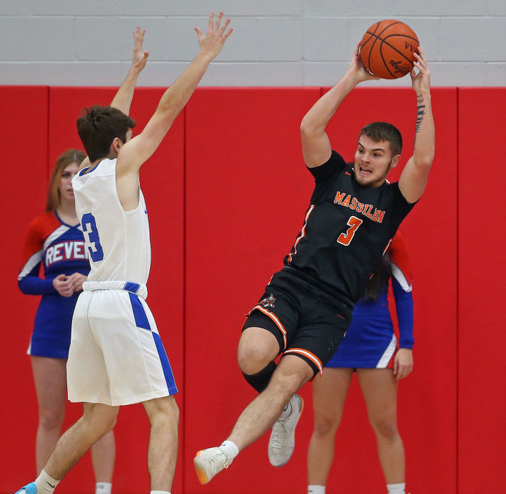 Sports - 1st place - Massillon's Luke Sabo leaps to keep the ball in bounds against Revere's Nolan Williams during the first half of a game at Revere High School in Bath. Jeff Lange / Akron Beacon Journal