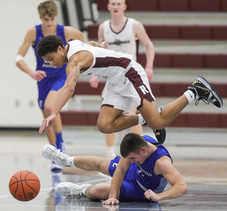 Sports - 2nd place - Rossford’s Camron Gaston trips over Elmwood’s Kyler Heiserman while chasing a loose ball during a game in Rossford. Rossford defeated Elmwood, 75-43.  Jeremy Wadsworth / The Blade