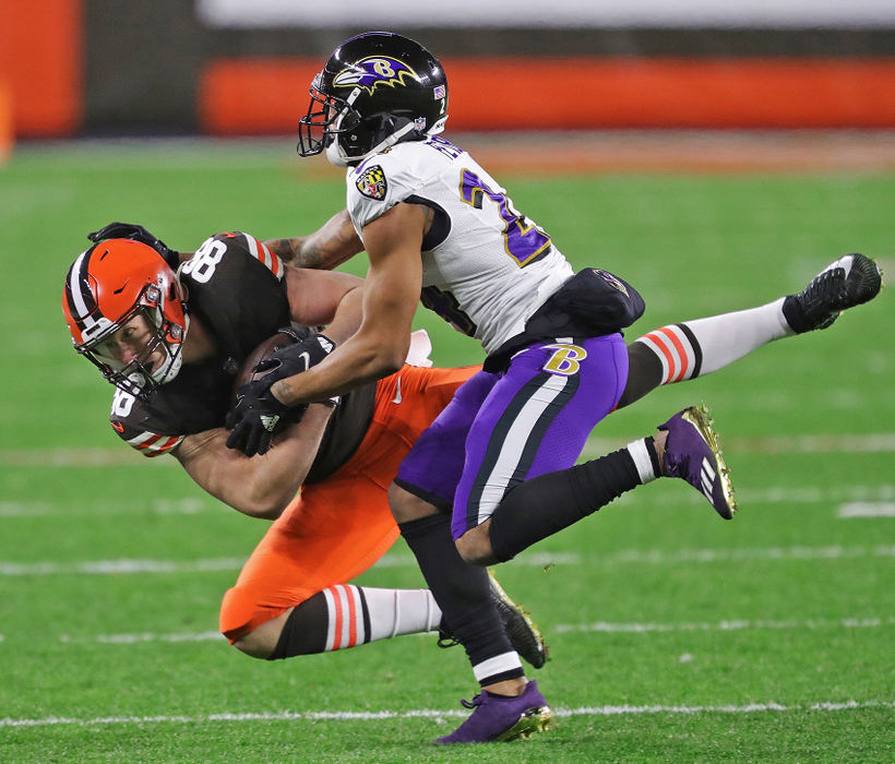 Sports - HM - Cleveland Browns tight end Harrison Bryant (88) is brought down by Baltimore Ravens cornerback Marcus Peters (24) after a reception during the first half of a game in Cleveland. Jeff Lange / Akron Beacon Journal