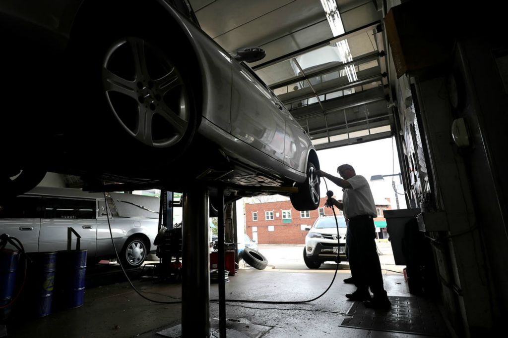 Story - 1st place - Jim Amer, owner of Amer’s West Hill Marathon, puts air in a customer’s tires in Akron. After more than 70 years, Amer’s West Hill Marathon will close up before becoming Van’s Tire as Jim Amer is retiring. (Jeff Lange / Akron Beacon Journal) 