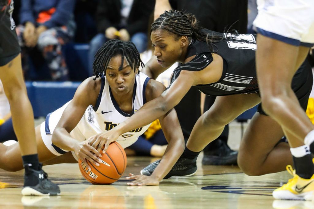 Sports - 2nd place - Toledo’s Halle Idowu (left) and St. Francis’ Jada Dapaa reach for a loose ball during a game at the University of Toledo’s Savage Arena. (Rebecca Benson / The Blade) 