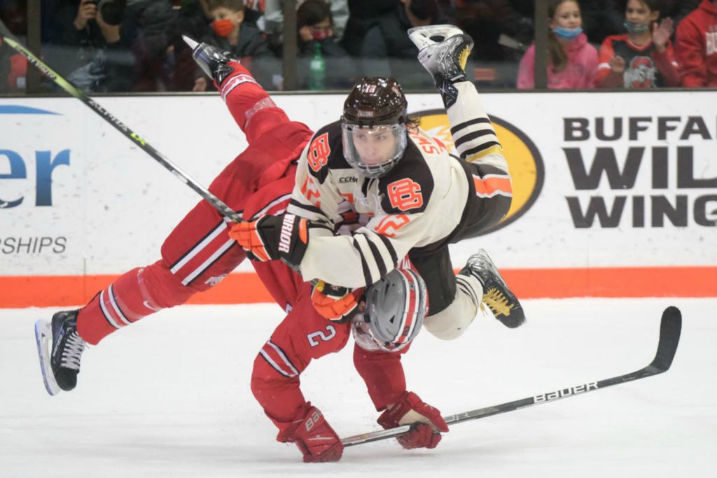 Sports - 3rd place - Bowling Green State University's Austen Swankler (top) flips over Ohio State's James Marooney  at the Slater Family Ice Arena in Bowling Green.  (J.D. Pooley / Sentinel-Tribune ) 