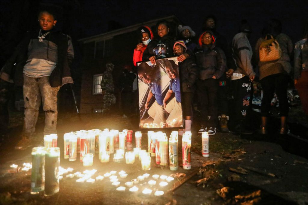 Story - 3rd place - Family of Amare Lockett huddle together and console one another during a candle light vigil for 9-year-old Amare Lockett who died in a house fire in Toledo. (Rebecca Benson / The Blade) 