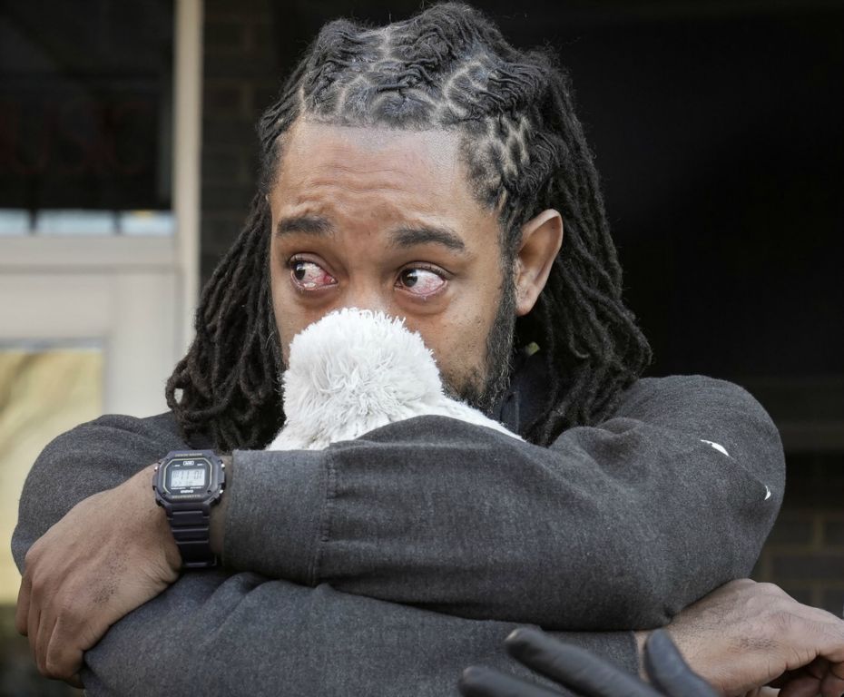 General News - 2nd place - Jermaine Mitchell, cousin to LaFonda Thomas, paternal grandmother to twins Ky'air and Kason Thomas, hugs Thomas during a prayer vigil held at the Donatos on North High Street where the boys were abducted. Ky'air was found at the Dayton International Airport. Kason is still missing.  (Barbara J. Perenic / The Columbus Dispatch)