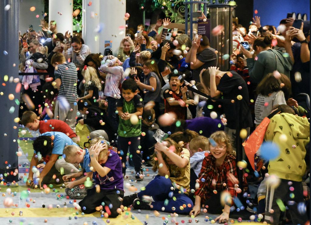 General News - 3rd place - Children take cover as 23,000 bouncy balls are dropped at 2:23 pm during the New Year’s Eve EVE Bouncy Ball Drop at Imagination Station in Toledo.  (Jeremy Wadsworth / The Blade)