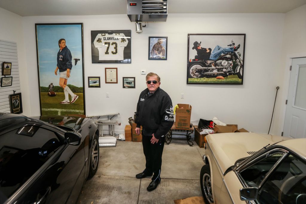 Portrait - HM - Perrysburg native Jerry Glanville stands surrounded by cars, art and memorabilia from his time as a Perrysburg High School football player and NFL coach at his home in Perrysburg.  (Isaac Ritchey / The Blade)