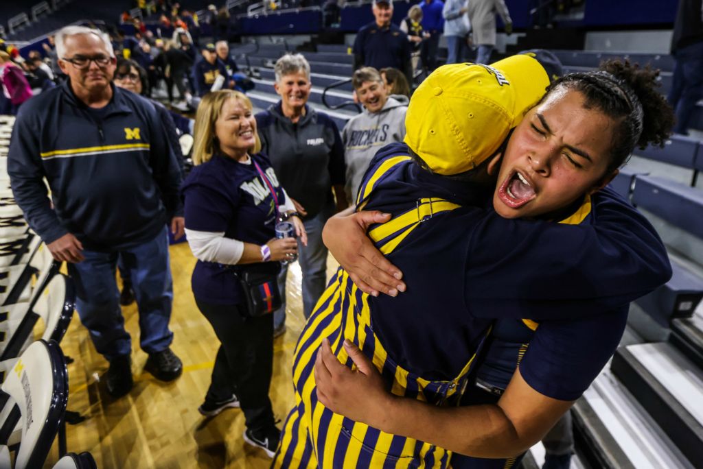 Sports Feature - 1st place - Superfan Karen Zach (left) embraces Toledo Rockets forward Nan Garcia after a 71-68 upset win over the 14th-ranked Michigan Wolverines In a women’s basketball game at Crisler Arena in Ann Arbor.  (Isaac Ritchey / The Blade)