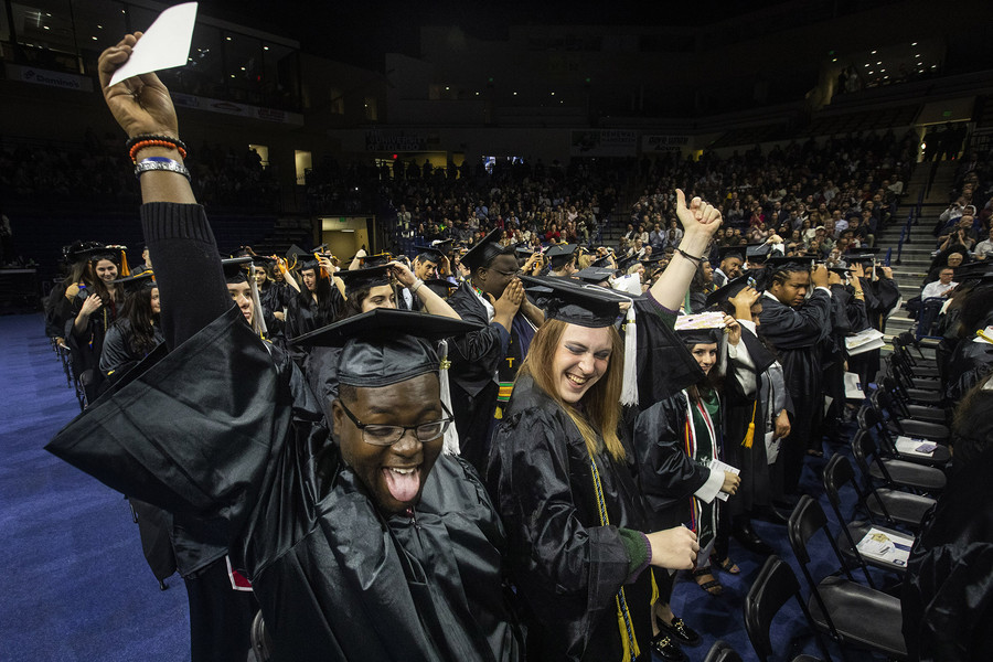 General News - 3rd place - Jayy Smith and Hazel Penrose dance after turning their tassels during UT’s class of 2023 fall commencement at the University of Toledo’s Savage Arena. (Rebecca Benson / The Blade)