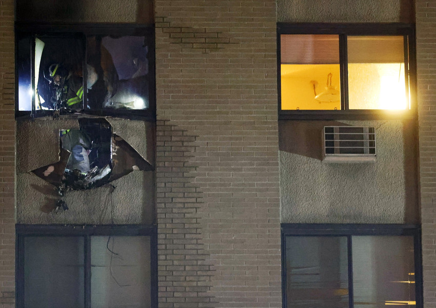 Spot News - 1st place - Firefighters clear debris after containing an apartment fire on the sixth floor of the TenEyck Towers in Toledo. (Kurt Steiss / The Blade)