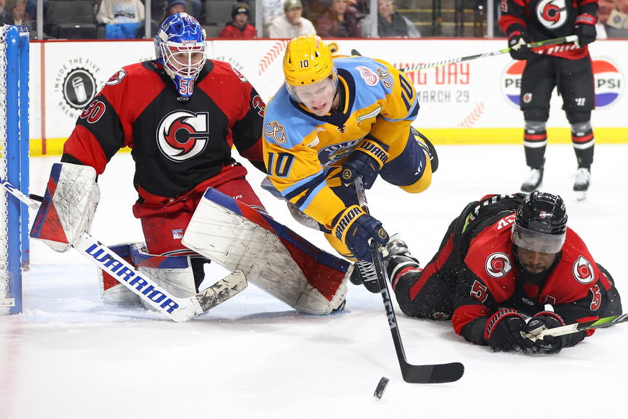 Sports - 3rd place - Toledo’s Riley Sawchuk (center) and Cincinnati’s Jalen Smereck (right) dive for the puck during an ECHL hockey game  at the Huntington Center in Toledo. (Kurt Steiss / The Blade)