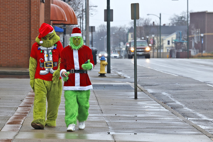 Feature - 1st place - Everyone should hide their Christmas presents because their were a couple of Grinches walking along High Street in Springfield. The Grinches were actually Elijah Parsons (left)] and Jeremy Byron who said they were just trying to spread a little Christmas joy.  (Bill Lackey / Springfield News-Sun)