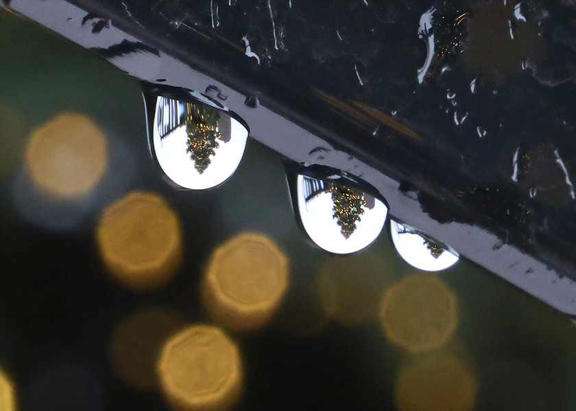 Feature - 3rd place - The spirit of the holiday season in a drop of rain as the Springfield Christmas tree is reflected in the rain drops hanging from a car window on a soggy Monday. (Bill Lackey / Springfield News-Sun)