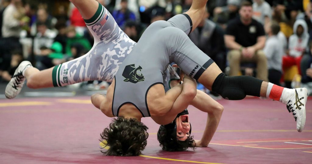 Sports - 1st place - Ethan Timar of St. Edward (right) and Liston Seibert of Massillon Perry flip during their 120 pound consolation match during the 2024 Ironman Wrestling Tournament at Walsh Jesuit High School in Cuyahoga Falls. (Jeff Lange / Akron Beacon Journal)