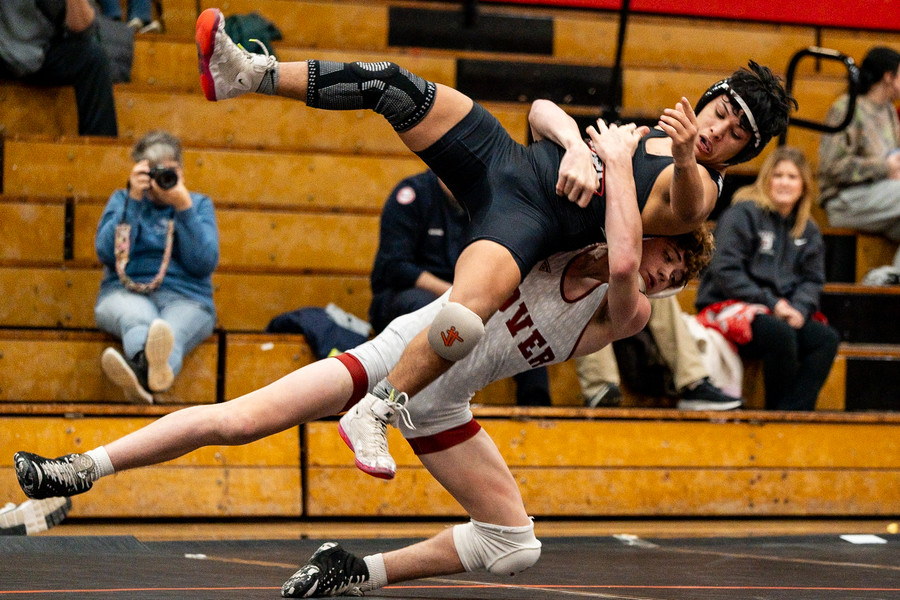 Sports - 2nd place - Dover's Patrick Moran throws New Philadelphia's Crespo Reyes during annual Dover-Phila duals at New Philadelphia High School. (Andrew Dolph / The Times Reporter)