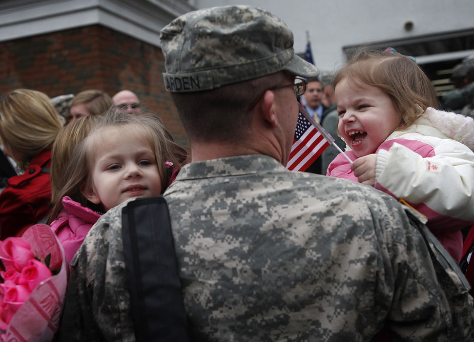 General News - 2nd place - Sisters Nora, (left) and Lily greet their dad Michael Carden II of Westerville during a Welcome Home Ceremony for the 196th Mobile Public Affairs Detachment at Reynoldsburg United Methodist Church.  (Jonathan Quilter / The Columbus Dispatch)