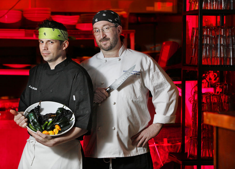 Portrait - 1st place - Barcelona chefs Aaron White (left) and Paul Yow with some of the tools and ingredients they will be using to compete in the Chef Chili Challenge taking place during the Fiery Foods Festival at the North Market.  (Chris Russell / The Columbus Dispatch)