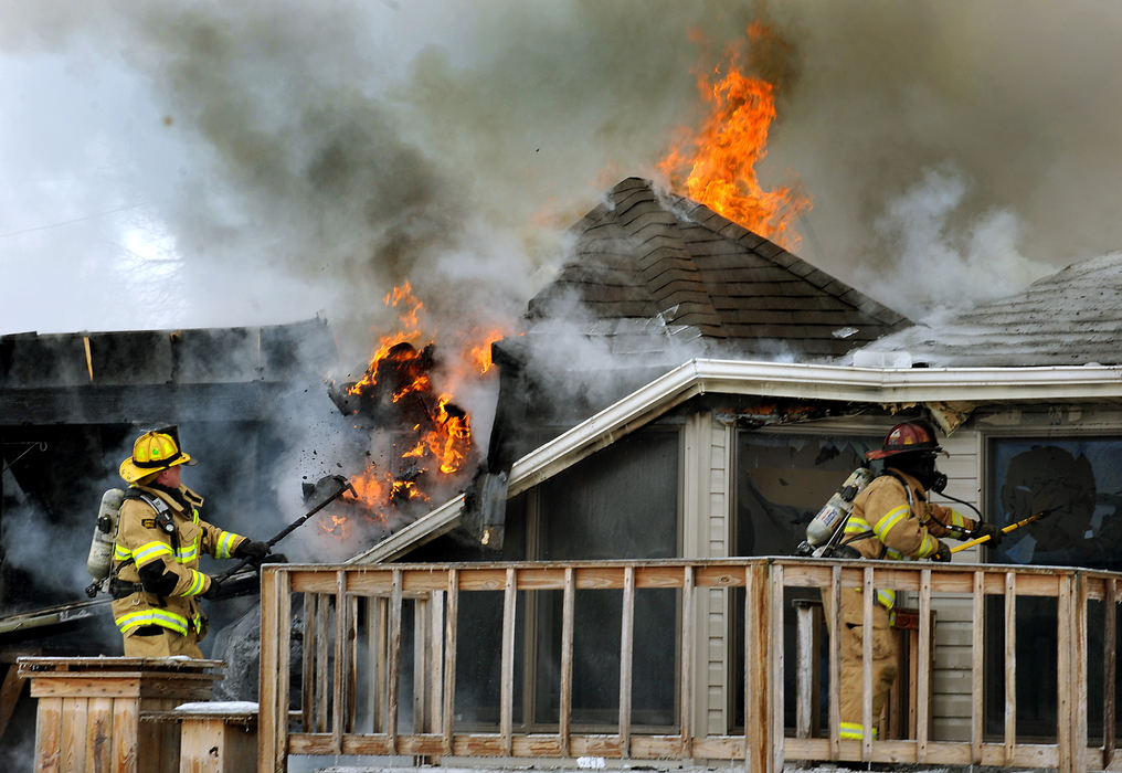 Spot News - 2nd place - Firefighters from several Clark County departments battle a fire as it consumes a house in Mad River Township. There were no injuries in the blaze but the house was completely destroyed.  (Bill Lackey / Springfield News-Sun)