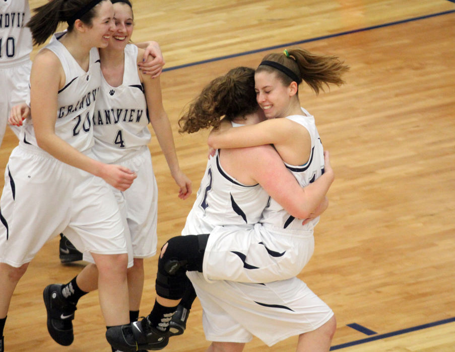 Sports - 3rd place - Grandview's  Karen Daniel-Hamberg, and Jordan Fitzgerald put their arms around each other as teammates Kelly O'Harra and Danielle Clark hug as they celebrate their 37-35 tournament game win over Madison Plains at Granville. (Lorrie Cecil / ThisWeek Newspapers)