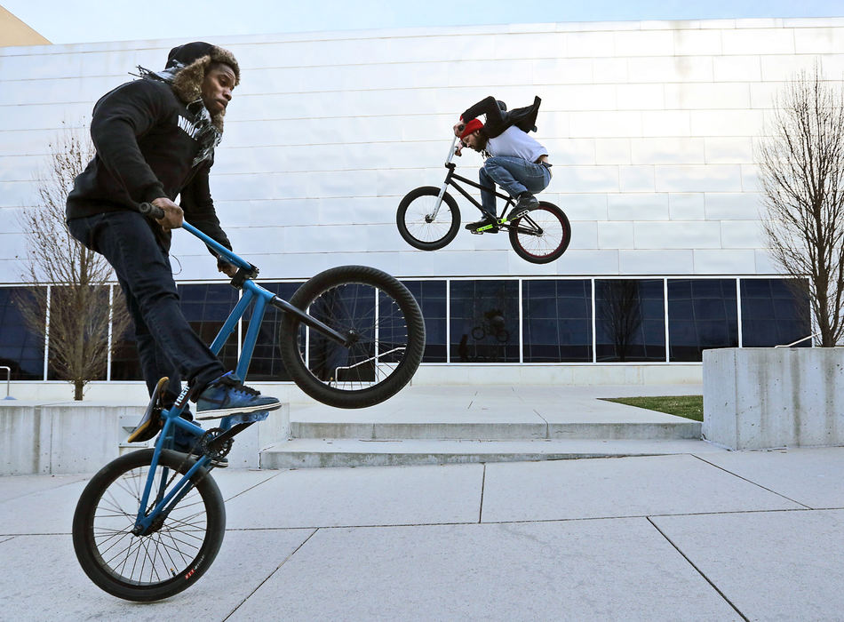 Feature - 1st placeSteve Carter (left) and Josh Long ride through Ohio State's campus popping wheelies and ramping across stone walkways. Long is a professional BMX rider, and Carter is a guitarist in a band. They frequently ride indoors at The Flow Skatepark during the winter, but when the weather warms up, they take to the streets.  (Adam Cairns / The Columbus Dispatch)