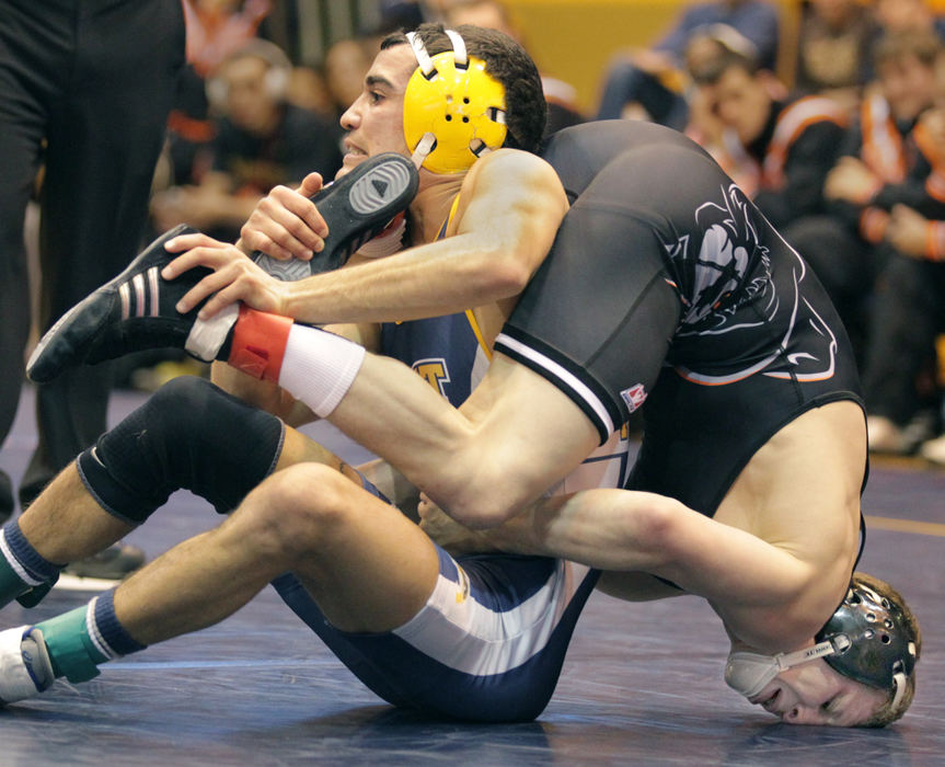 Sports - 1st placeKent State's Stevie Mitcheff (left) on his way to a 3-2 win over Oklahoma State's Eddie Kilmara  in a 125 pound match at the M.A.C. Center in Kent.   (Phil Masturzo / Akron Beacon Journal)