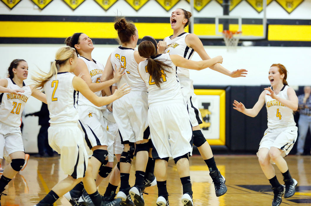 Sports Feature - 1st place - Sylvania Northview's Kendall McCoy (40) leaps into her teammates after the Wildcats defeated Sylvania Southview in overtime of their basketball game at Sylvania Northview High School. (Andy Morrison / The (Toledo) Blade)