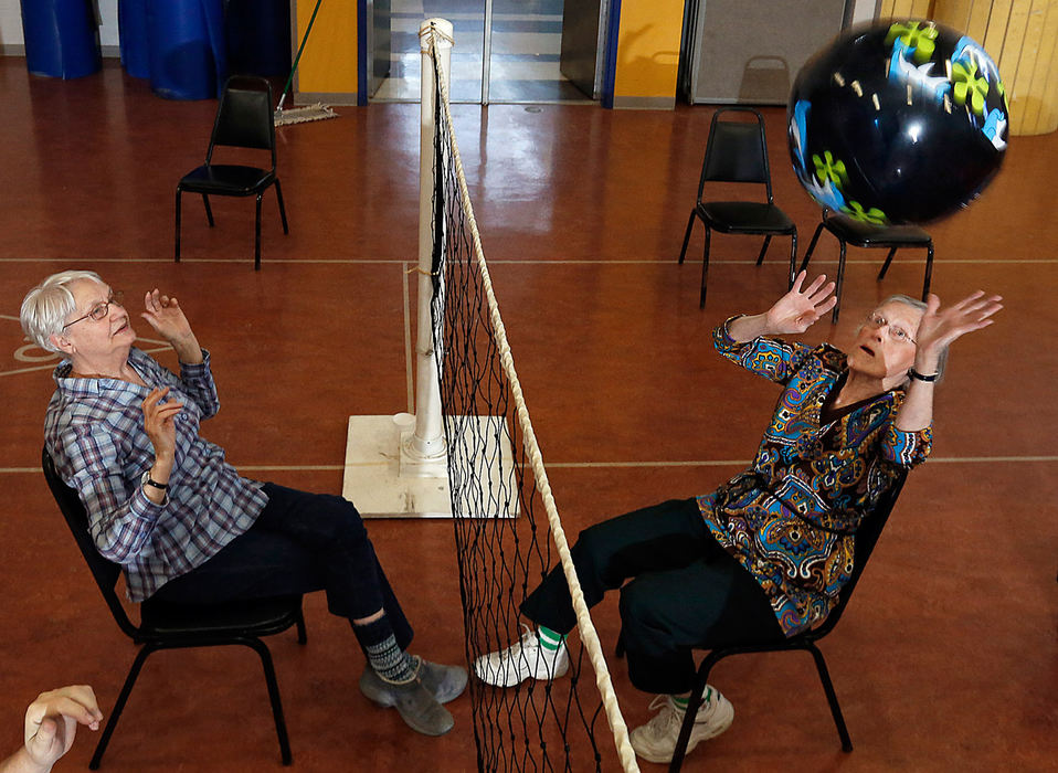 Sports Feature - 2nd place - (From left) Doreen Wright, 83, and Vonnie Spring, 90, battle it out during a friendly game of chair volleyball. The group meets twice a week, on Monday and Thursday at the Dodge Community Center. Today's game had 8 players with Vonnie, being the most senior and Doreen coming in second in age. They like to have 12 on a team.  (Tom Dodge / The Columbus Dispatch)