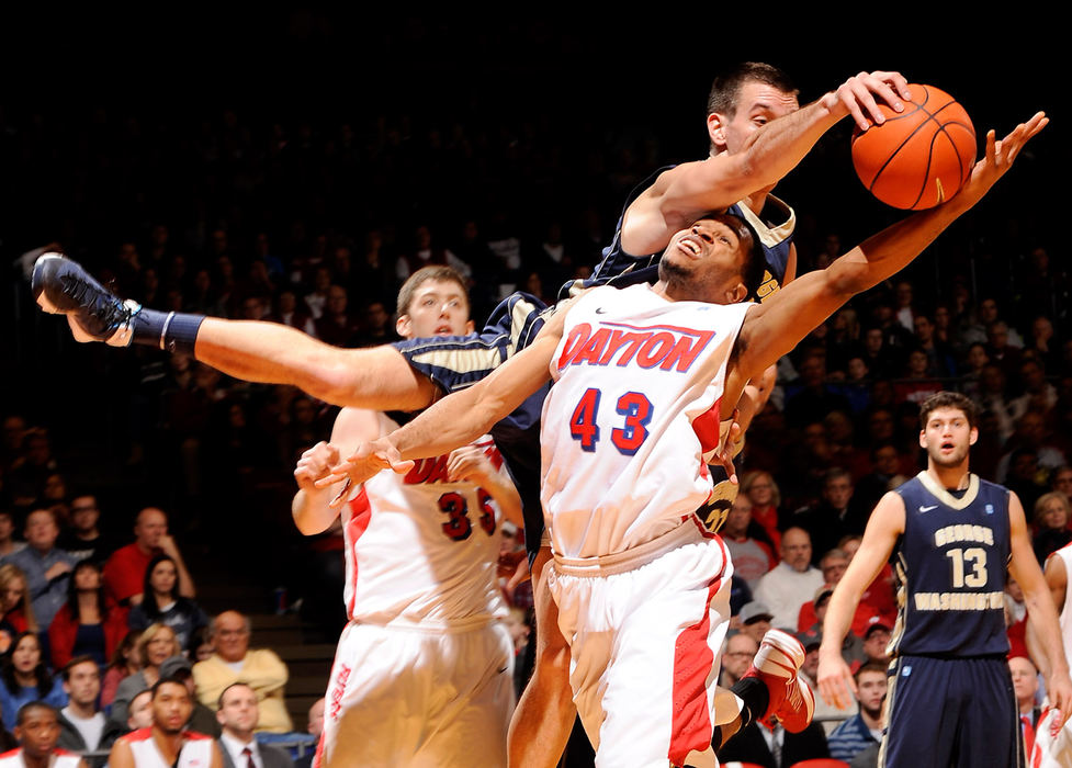 Sports - 1st place - Dayton's Vee Sanford battles for a rebound against Nemanja Mikic of George Washington. Dayton defeated GW 75-65 at UD Arena. (Erik Schelkun / Elsestar Images)