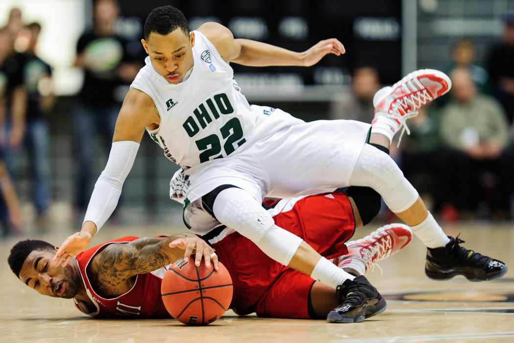 Sports - 3rd place - Miami guard Geovonie McKnight and Ohio guard Stevie Taylor dive for a loose ball in the Bobcats defeat the Miami RedHawks at The Convo in Athens, Ohio.  (Daniel Kubus / Ohio University )