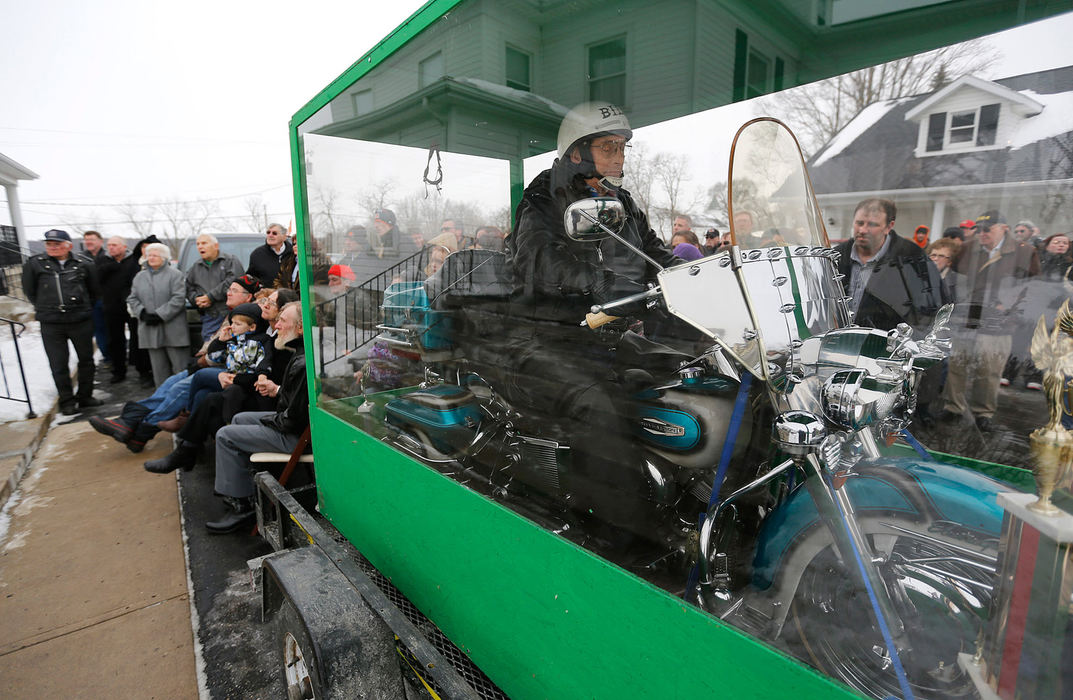 Story - 1st place - The body of Bill Standley secured to his 1967 Harley Davidson rests inside a plexiglass box during his funeral service in Mechanicsburg. Standley and his sons designed a brace that hooked into the bike and led up his back to surround his rib cage. Five years ago, Standley went before the Champaign County Board of Health, which told him he'd have to come up with a special vault and drain all the fluids out of the bike before he could be buried with it. (Jonathan Quilter / The Columbus Dispatch)