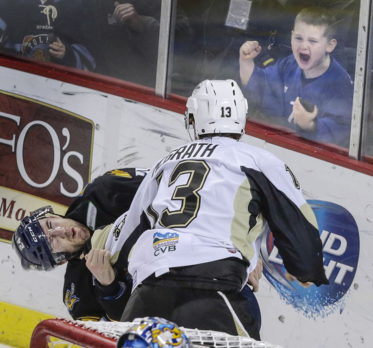 Sports Feature - 1st place - A young fan takes delight in a fight as Toledo Walleye player Shane Sims (24) goes down after being punched by Wheeling Nailers player Patrick McGrath (13) during the second period of their hockey game at the Huntington Center. (Andy Morrison / The (Toledo) Blade)