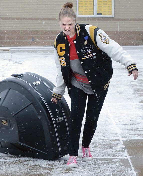 Feature - 1st place - With winter finally rearing its frigid head, members of the Crestview Marching Brigade bid it all farewell leaving for its first-ever trip to Disney World in Orlando. The Rebels will perform and enjoy the sun and warmth of Disney World. Alyssa Kordecki fends off the snow as she loads a sousaphone onto the bus. (Patricia Schaeffer / The (Lisbon) Morning Journal)