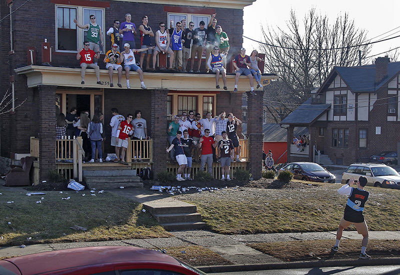 Feature - 2nd place - OSU sophomore mechanical engineering major Mick Mougey, right,  from Hudson, takes a group photo of his colleagues at the Kappa Sigma house on Lane Ave and Indianola. Mick said they were celebrating the nice day.  (Tom Dodge / The Columbus Dispatch)