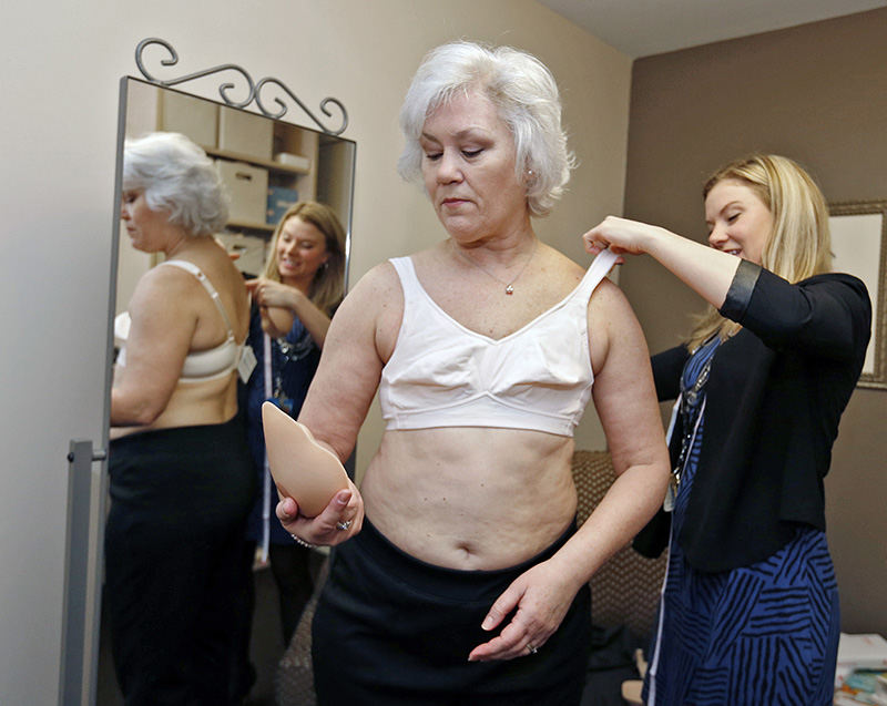 General News - 3rd place - Debbi Holland, 56, of Grove City, who had a double mastectomy without reconstruction during a battle with breast cancer, was fitted  for a custom breast prothesis by Rachel Brown, CFm, at the Over My Head Boutique in the Bing Cancer Center. New technology takes multiple scans of the individual patient and is custom-made to fit the contours of the body. These protheses are lighter in weight, cooler and more comfortable to wear. (Barbara J. Perenic / The Columbus Dispatch)