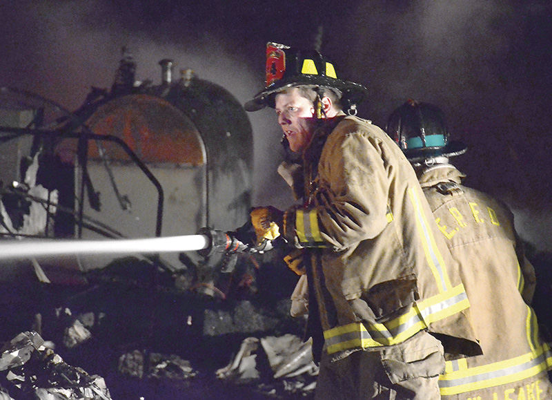 Spot News - HM - East Palestine firefighters Josh Sorell and Willard Leake hose down hot spots during a trailer fire. (Patricia Schaeffer / The (Lisbon) Morning Journal)