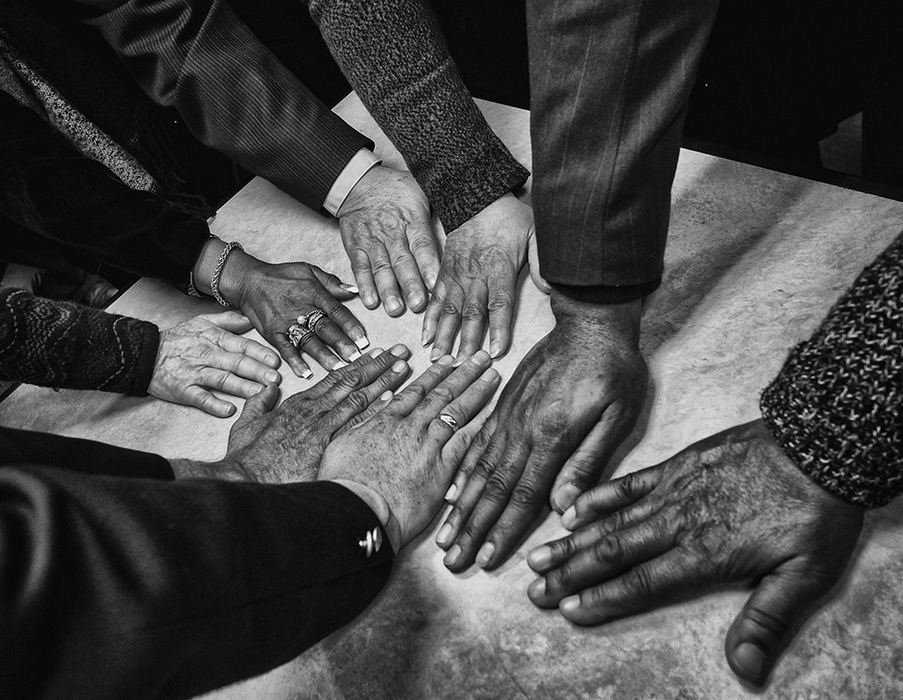    General News - HM - Leaders of diverse faiths including Islam, Christianity, and Buddhism lay hands next to each other as  a sign of unity during a rally at The Grape Leaf Diner in Holland, Ohio. The rally was in response to the President Donald Trump's travel ban. (Jeremy Wadsworth / The Blade)