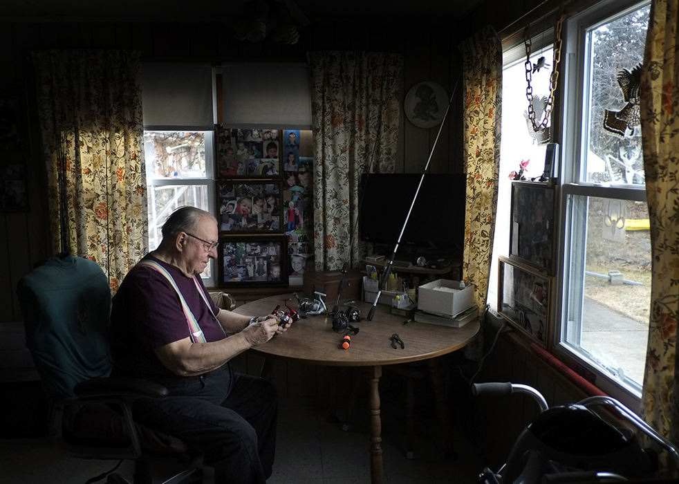 Portrait - 2nd place - Jim Granner, 91, works on fishing reels in his Point Place, Toledo home. Granner does most of the repairs for Bass Pro's rod & reel donation program. He fixes the equipment and his sportsman's club donates the fishing gear to the needy.    (Andy Morrison / The Blade)