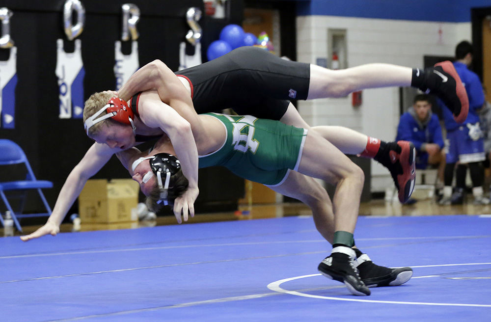 SPSports - 3rd place - Newark Catholic's J.T. Brown slams St. Charles' Troy Hungerford to the mat in the 138-pound weight class match at Bexley High School. (Shane Flanigan / ThisWeek Community News)