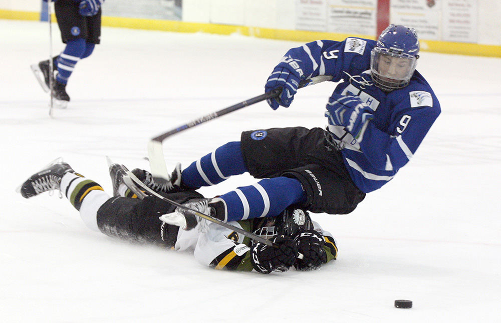 SPSports - HM - Newark's Tyler Dickerson upends Hilliard's Ty Spangler during a game att Lou & Gib Reese Ice Arena in Newark. (Shane Flanigan / ThisWeek Community News)