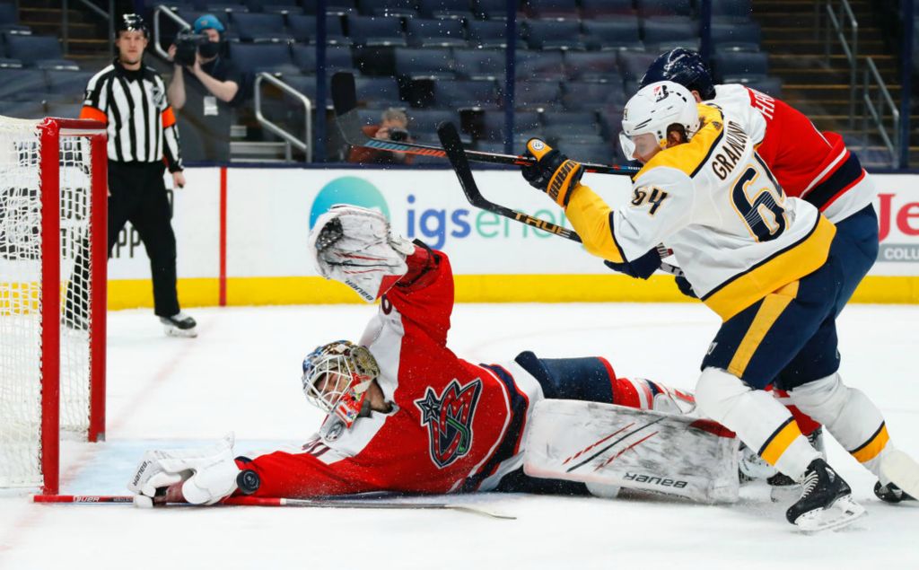 Sports - 1st place - Columbus Blue Jackets goaltender Elvis Merzlikins (90) makes a diving save of a Nashville Predators center Mikael Granlund (64) shot during the second period of their game at Nationwide Arena in Columbus. (Kyle Robertson / The Columbus Dispatch)