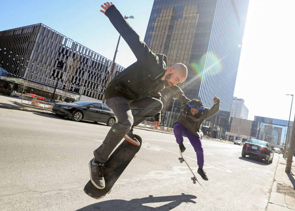 Feature - 1st place - Ryan Gongaware, of Bowling Green (left) and Osi Okoro, of Toledo, practice their skateboarding tricks at Madison Avenue and St. Clair Street in downtown Toledo. (Kurt Steiss / The Blade)