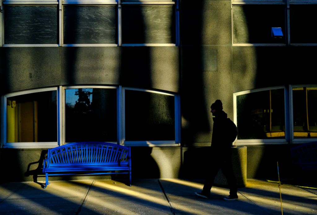 Feature - 2nd place - A man walks in the evening light towards Summit Street in Toledo. (Jeremy Wadsworth / The Blade)