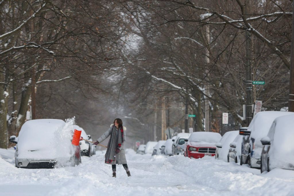 Feature - 3rd place - Caitlin Borke shovels the snow on Scottwood Avenue in the Old West End in Toledo.  (Rebecca Benson / The Blade)