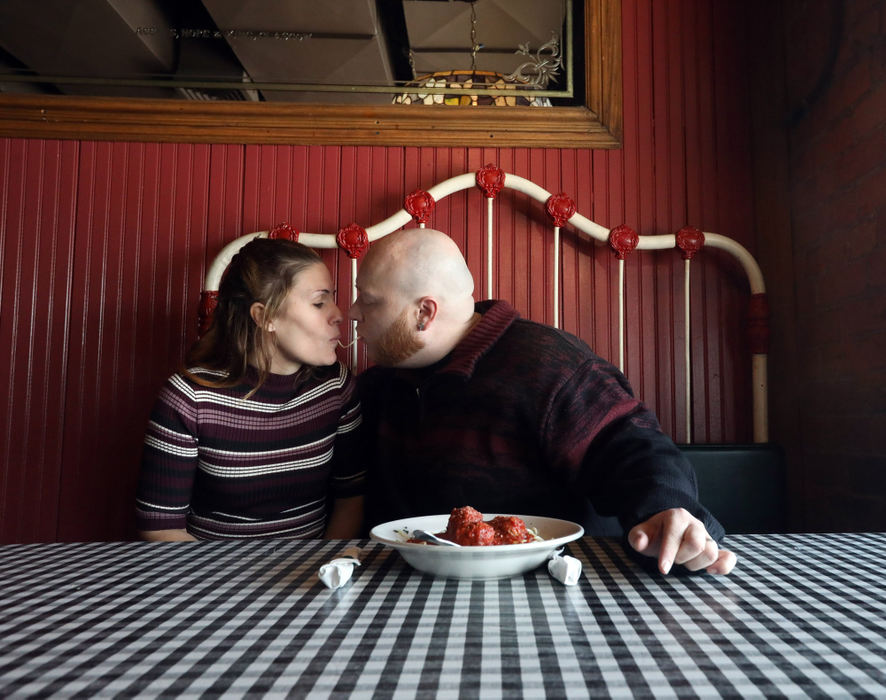 General News - 1st place - Newly married couple Theresa Tokles and James Putman react a scene from the Disney movie Lady and the Tramp at the Spaghetti Warehouse in downtown Toledo. (Amy E. Voigt / The Blade)