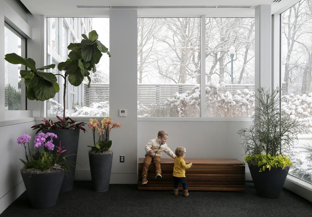 General News - 2nd place - Parker Lump, 3, and 1-year-old Avery Lump of Hilliard, wait for their friends to arrive in the lobby of the Franklin Park Conservatory. The children were accompanied by their mother, Caity Lump, who was looking for indoor activities to entertain her children while it's cold and snowy outside. (Barbara J. Perenic / The Columbus Dispatch)