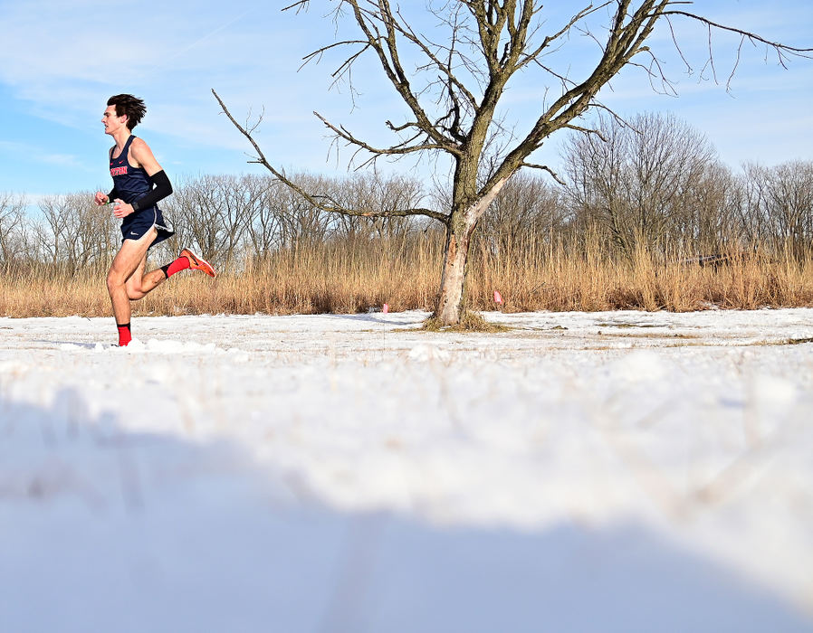 Sports - 2nd place - Dayton's Calen Gizelbach races in the snow on the way to his 1st place finish at the Wright State Invitational held at Fairborn Community Park in Fairborn. Gizelbach winning time for the 8000 meter race was 24:57. (Erik Schelkun / Elsestar Images)