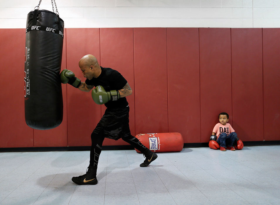 Sports Feature - 1st placeFebruary - 1st place Sports FeatureFive-year-old Andrew Cannon watches as boxer Jamie Walker of Columbus trains for an upcoming fight at the Douglas Community Center in Linden. (Adam Cairns/The Columbus Dispatch)