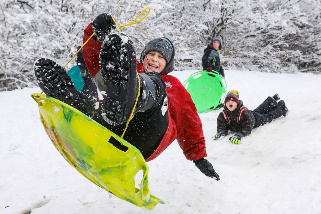 Feature - 1st place - Brady Cook, 13, catches air while sledding down a hill at Pearson Metropark in Oregon, Ohio.  (Rebecca Benson / The Blade)