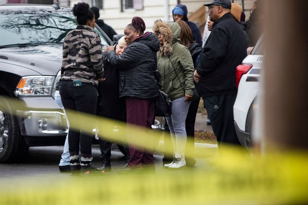 Spot News - 1st place - Judy Savage (center) is held by family and friends as her nephew, who was found dead in a house, is brought out on a gurney on the 1100 block of Buckingham Street in Toledo, on February 22, 2020.  (Rebecca Benson / The Blade)