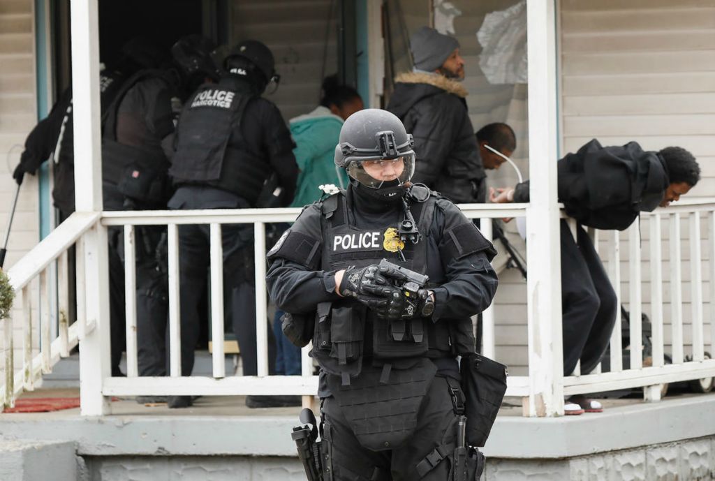 Spot News - 3rd place - Members of the Columbus Police Investigative Tactical Unit execute a judge's orders remove anyone inside the house at 1667 Minnesota Avenue in North Linden that the City of Columbus deemed a public nuisance. The Environmental Blight Abatement Team then boarded up the house after six people were removed.  (Adam Cairns / The Columbus Dispatch)