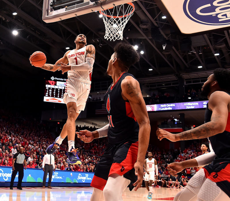 Sports - 1st place - Dayton's Obi Toppin performs a windmill dunk as the Duquesne defense watches.  (Erik Schelkun / Elsestar Images)